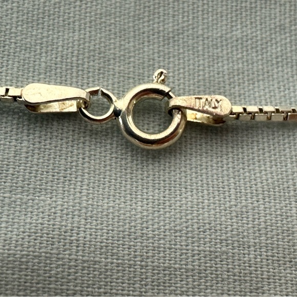 Silver pendant with gold star on the front and an arrow on the back. - Picture 2 of 5